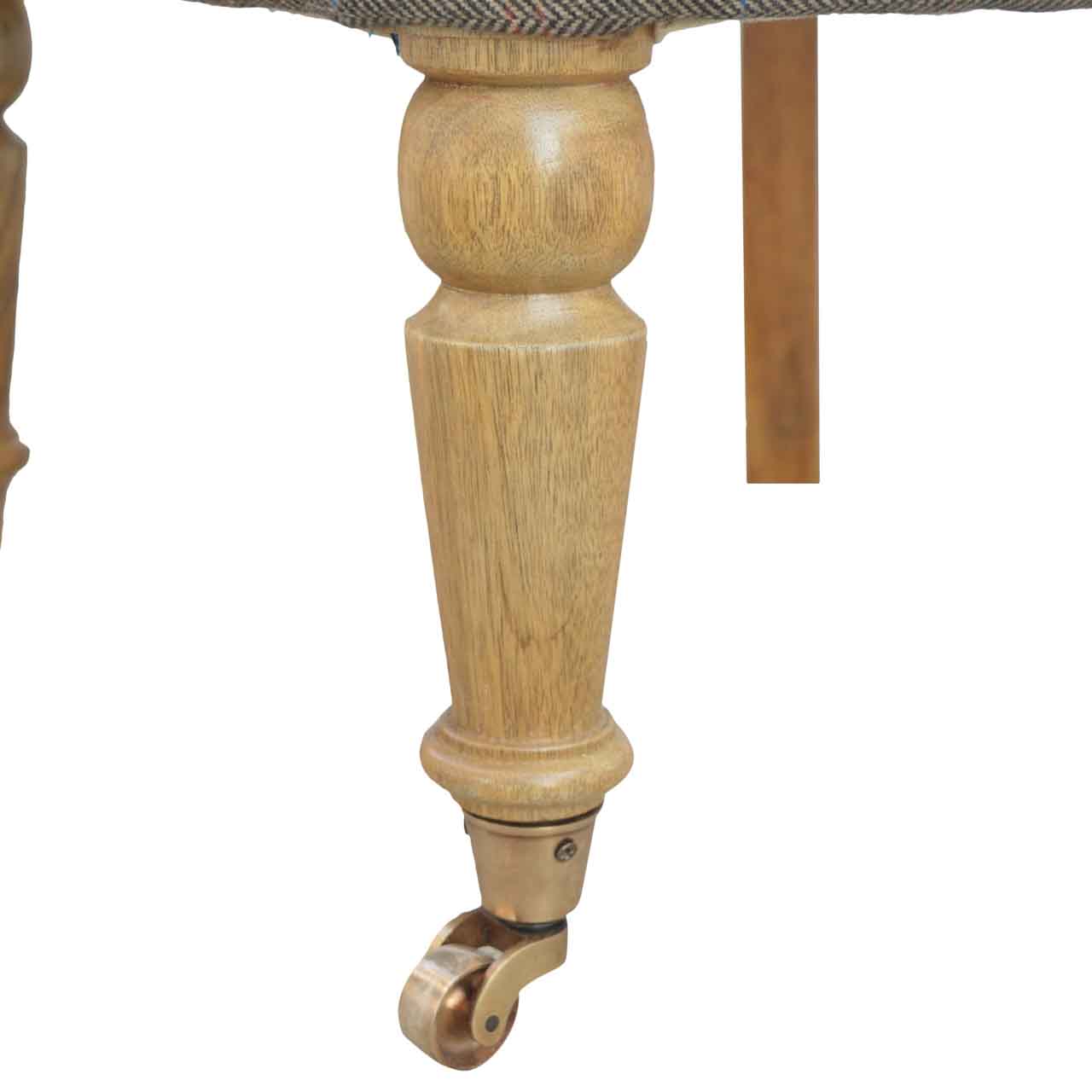 Tweed occasional chair Close-up of a wooden chair leg with a caster wheel