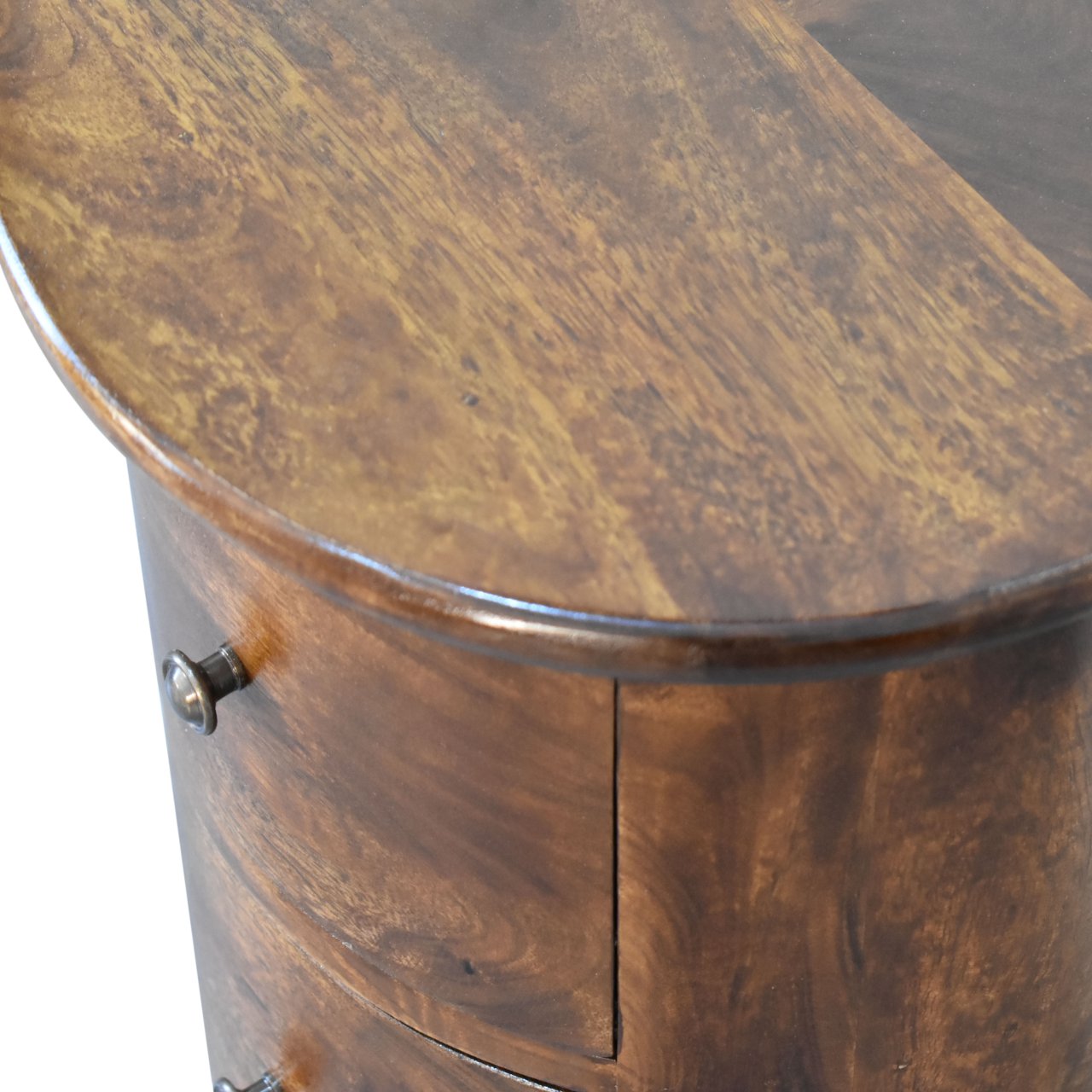 Drum Bedside Table with Drawers Close-up of a wooden bedside cabinet with a curved top