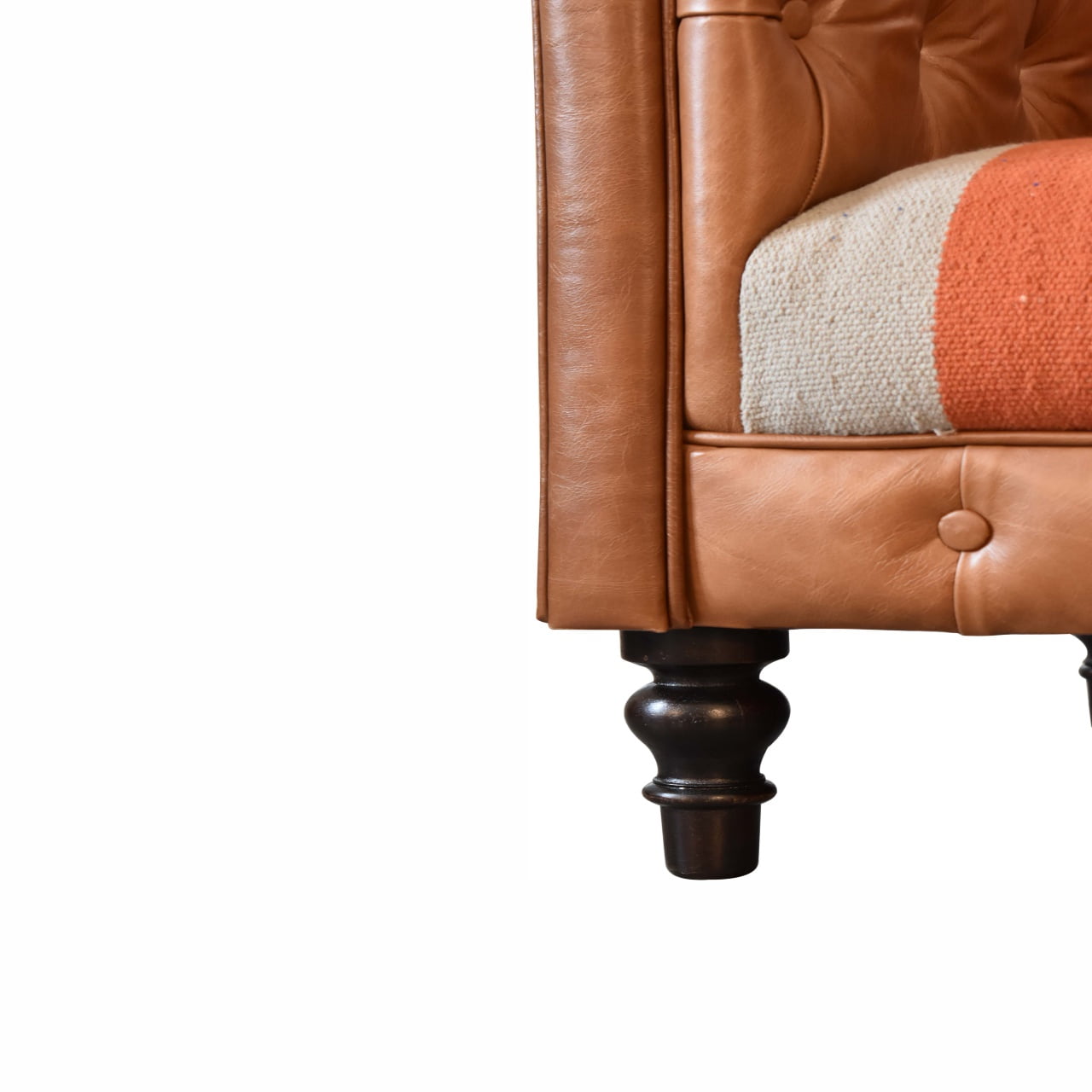 luxury leather and fabric mix sofa Close-up of a brown leather sofa with a wooden legs 