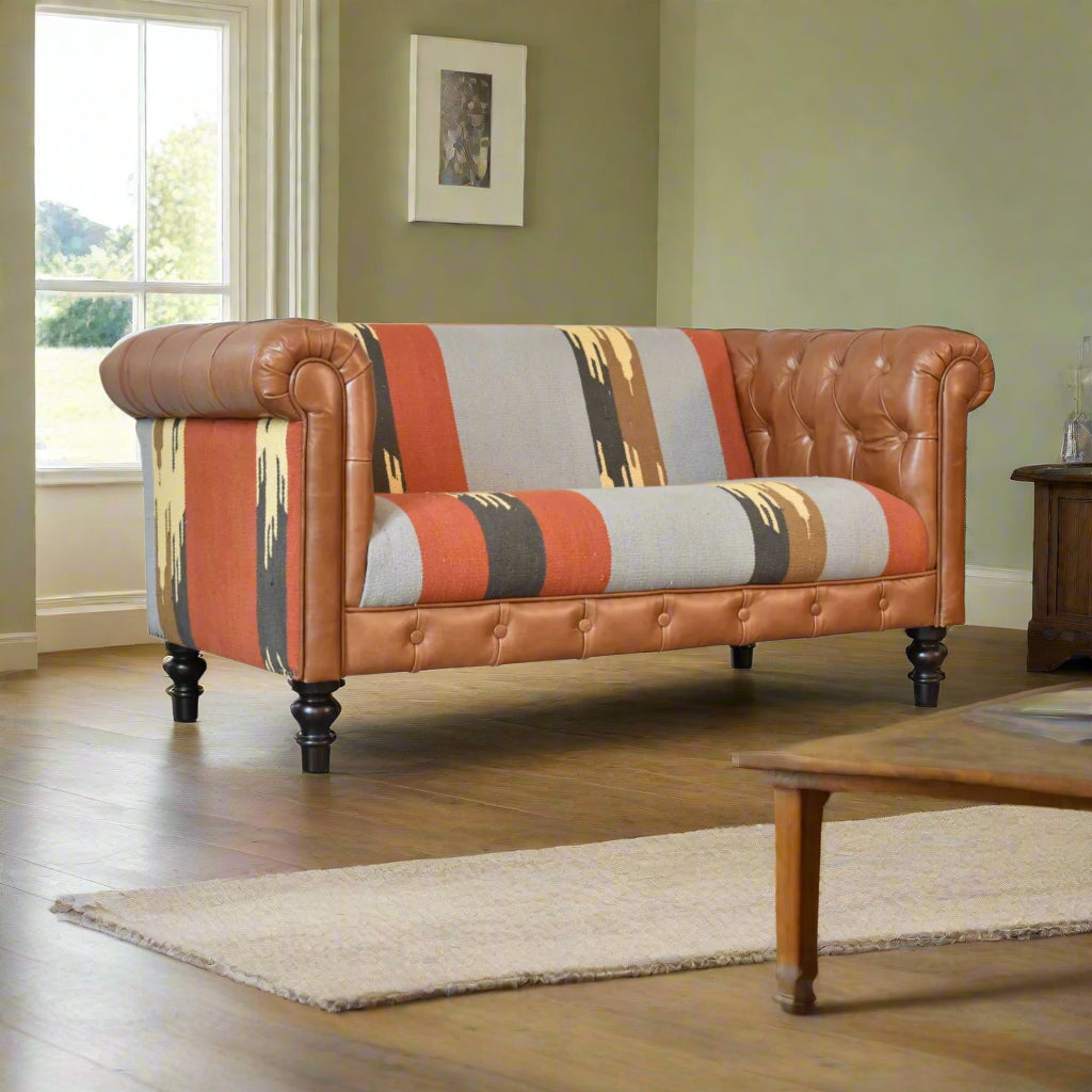 Multicoloured sofa with brown leather trim in a sitting room