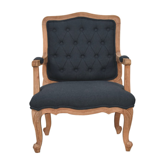 French style chair with arms. Chair with black tufted backrest and wooden frame 