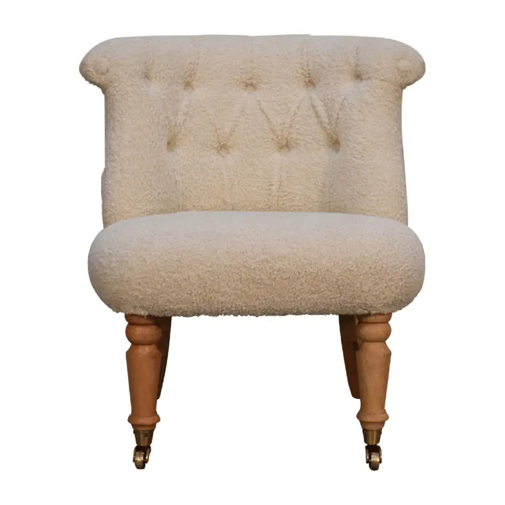 Cream boucle accent chair. Small chair with cream cushioned seat and backrest 
