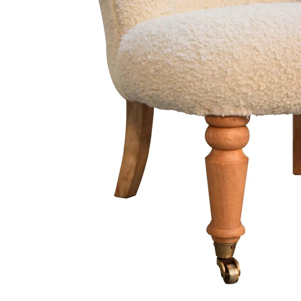 Cream boucle accent chair. Chair with wooden legs and a fluffy cream cushion  seat