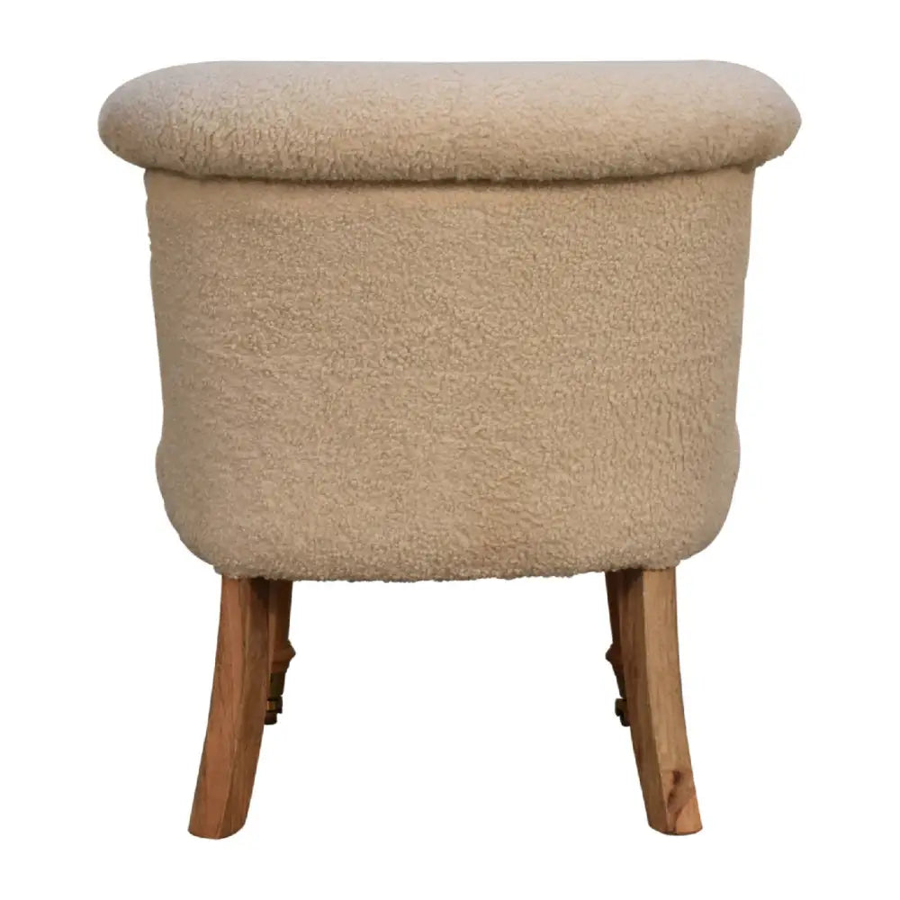 Cream boucle accent chair. Cream fabric ottoman with wooden legs 