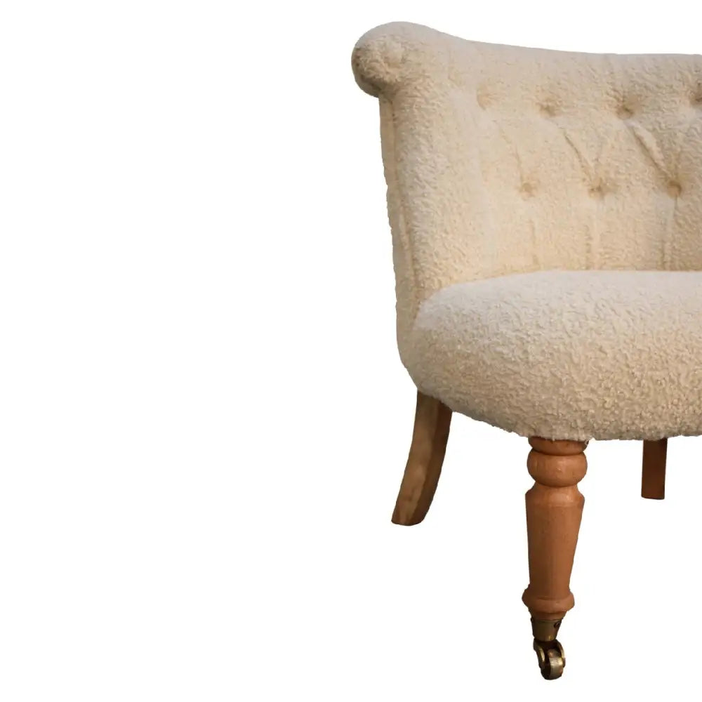 Cream boucle accent chair. Upholstered chair with wooden legs 