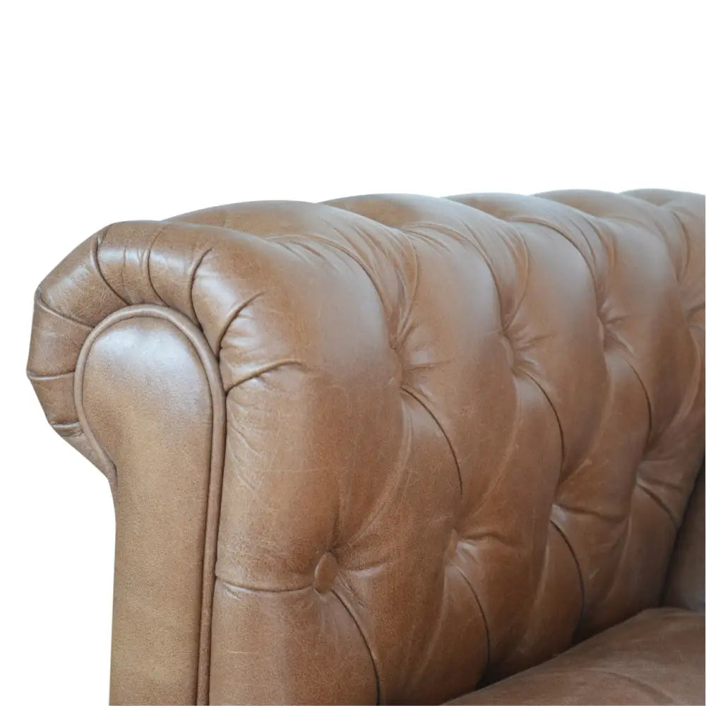 Buffalo leather chesterfield sofa. Close-up of a brown leather sofa with tufted backrest