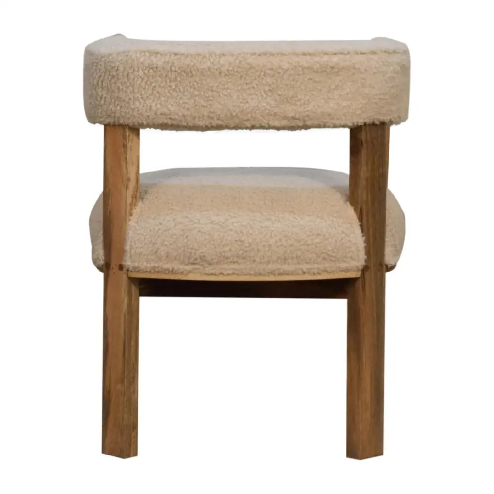 Boucle and wood occasional chair, with wooden legs and cream cushioned seat and backrest