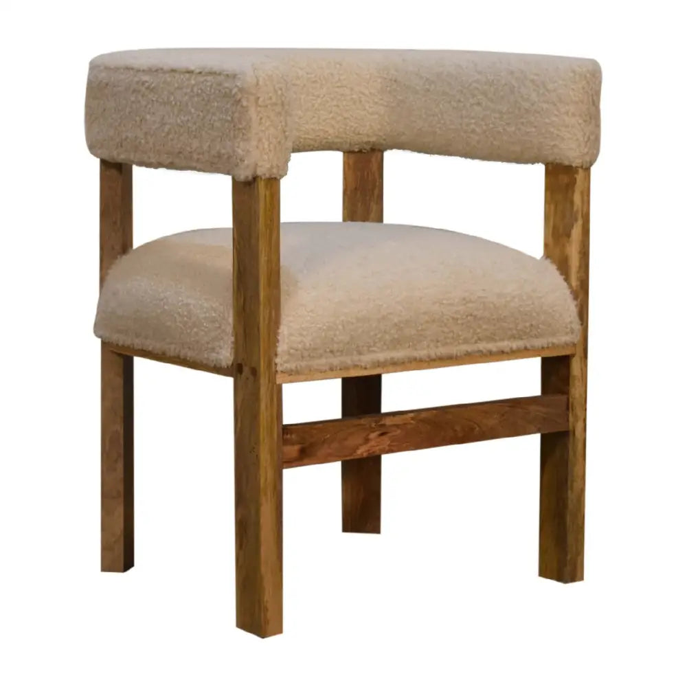 Boucle and wood occasional chair. Chair with wooden frame and beige cushioned seat and backrest 