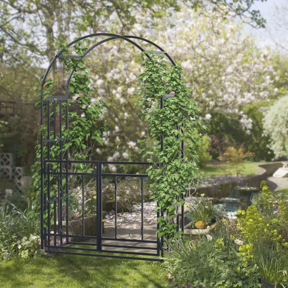 Elegant steel garden arch with gate. Black metal garden archway 