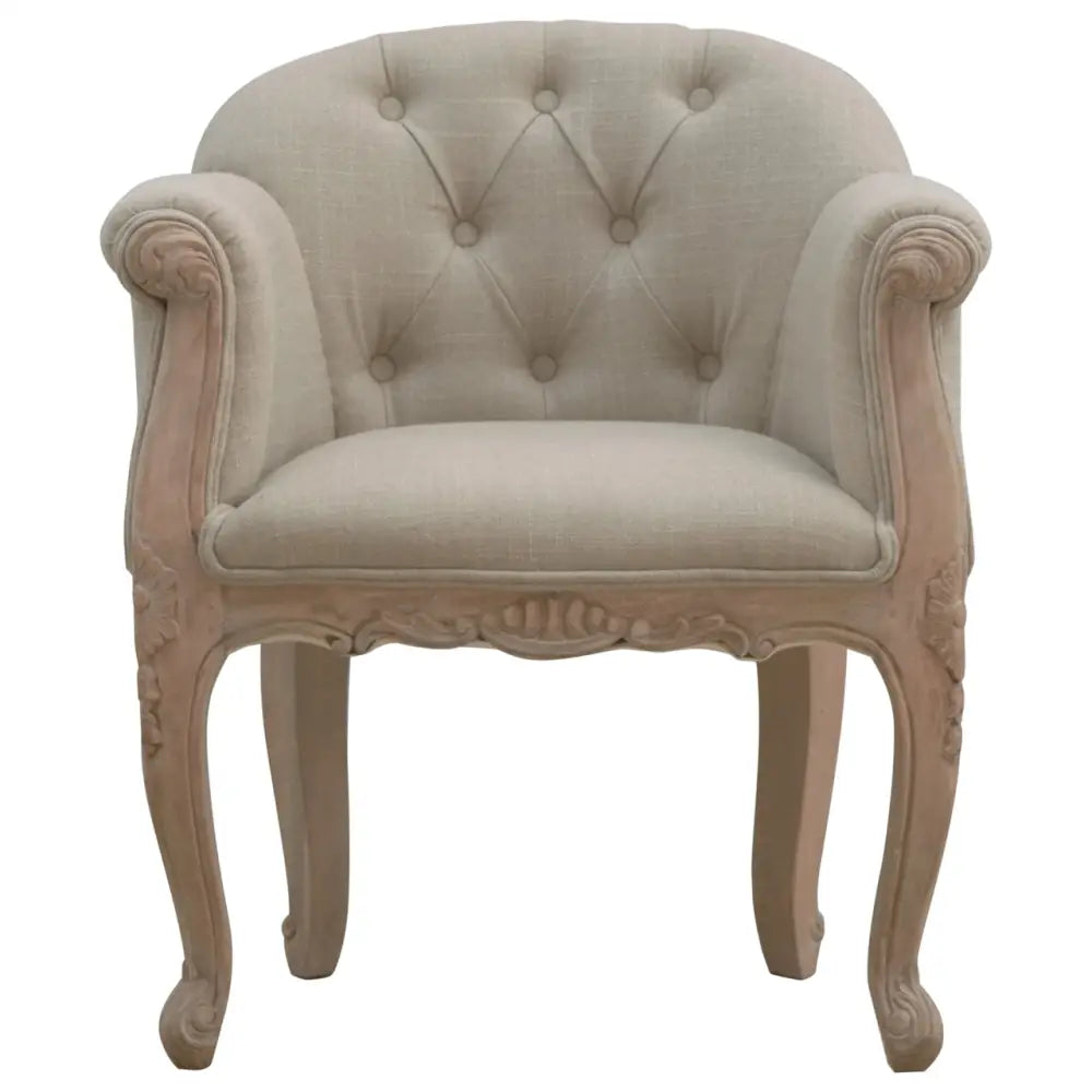 French Style Bedroom Chair. Decorative armchair with tufted backrest and ornate wooden frame 