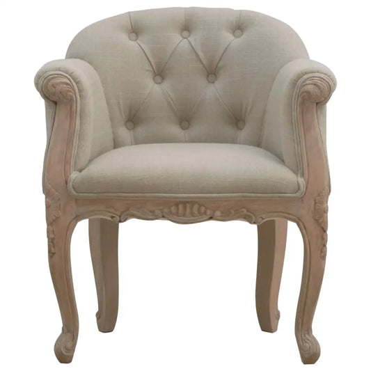 French Style Bedroom Chair. Decorative armchair with tufted backrest and ornate wooden frame 