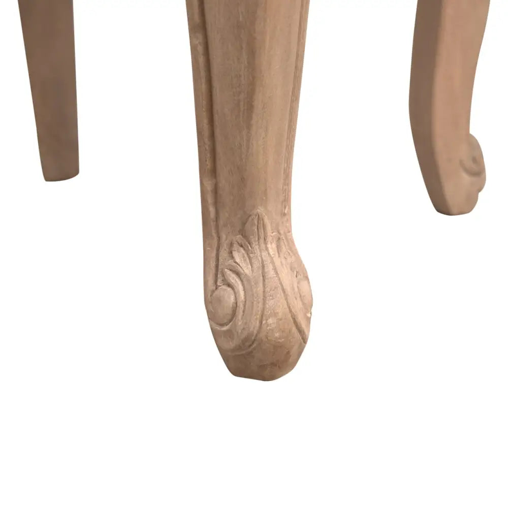 French Style Bedroom Chair. Close-up of a wooden leg with intricate carvings 