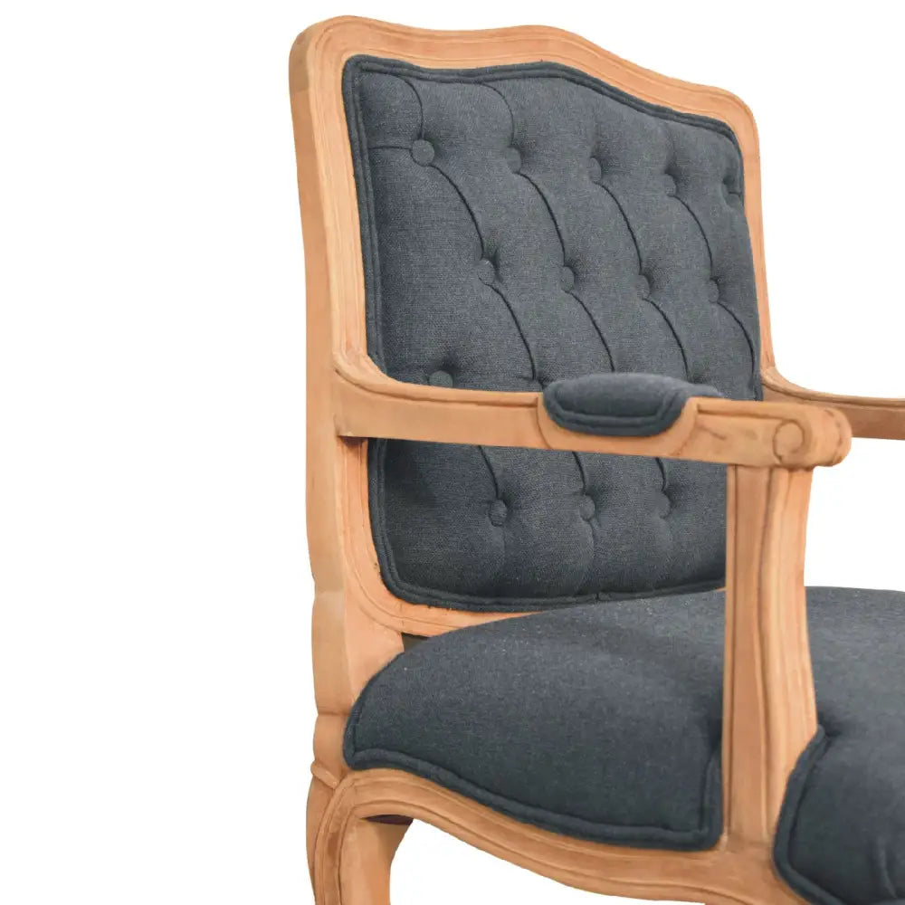 French style chair with arms. Chair with wooden frame and grey cushioned seat and backrest 