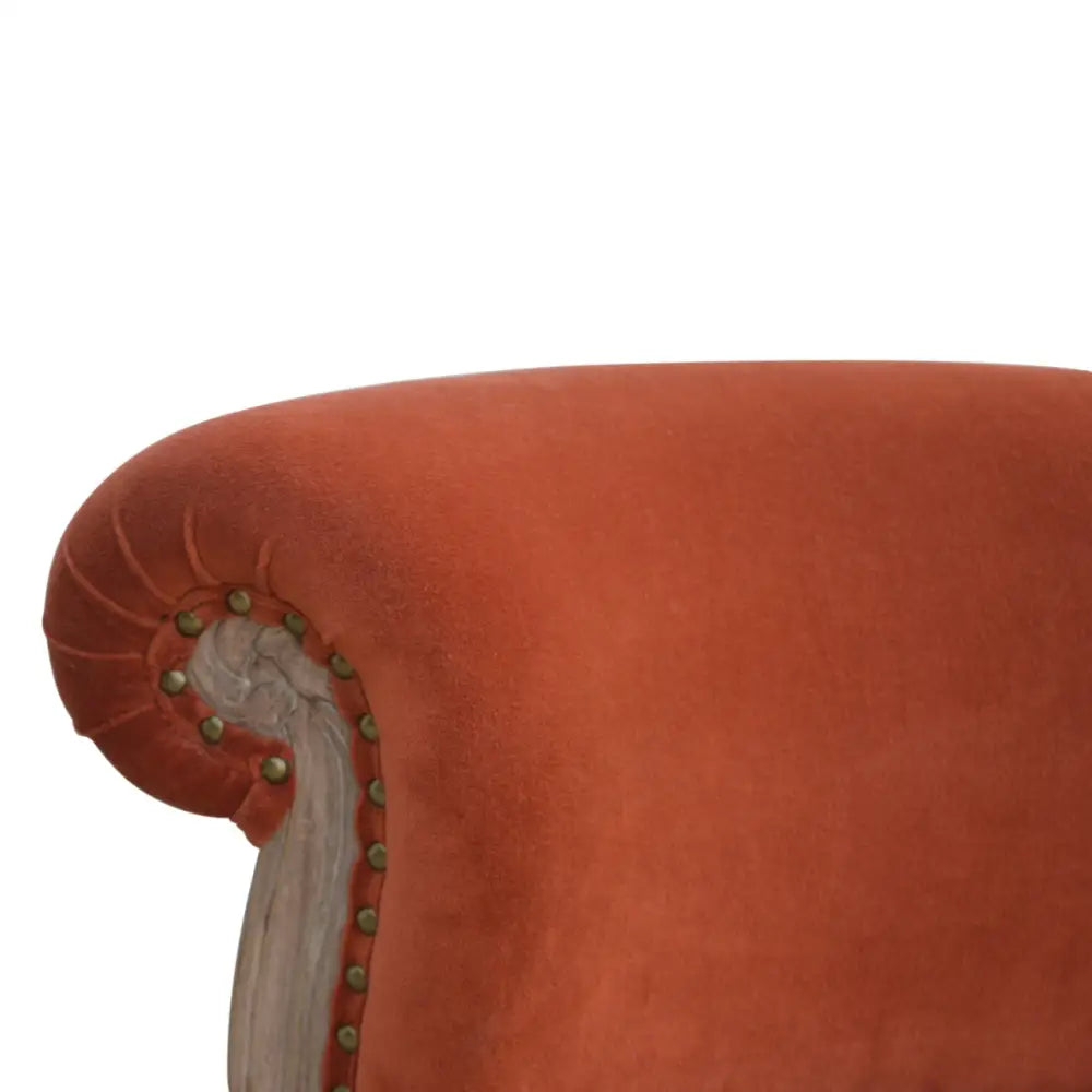 French Style Chair. Close-up of a upholstered chair with decorative nailhead trim. Available in various sumptuous colours