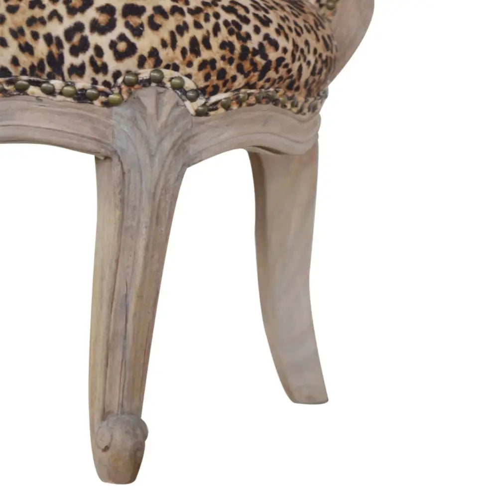 Leopard Print Velvet Chair. Chair with leopard print fabric and wooden legs 