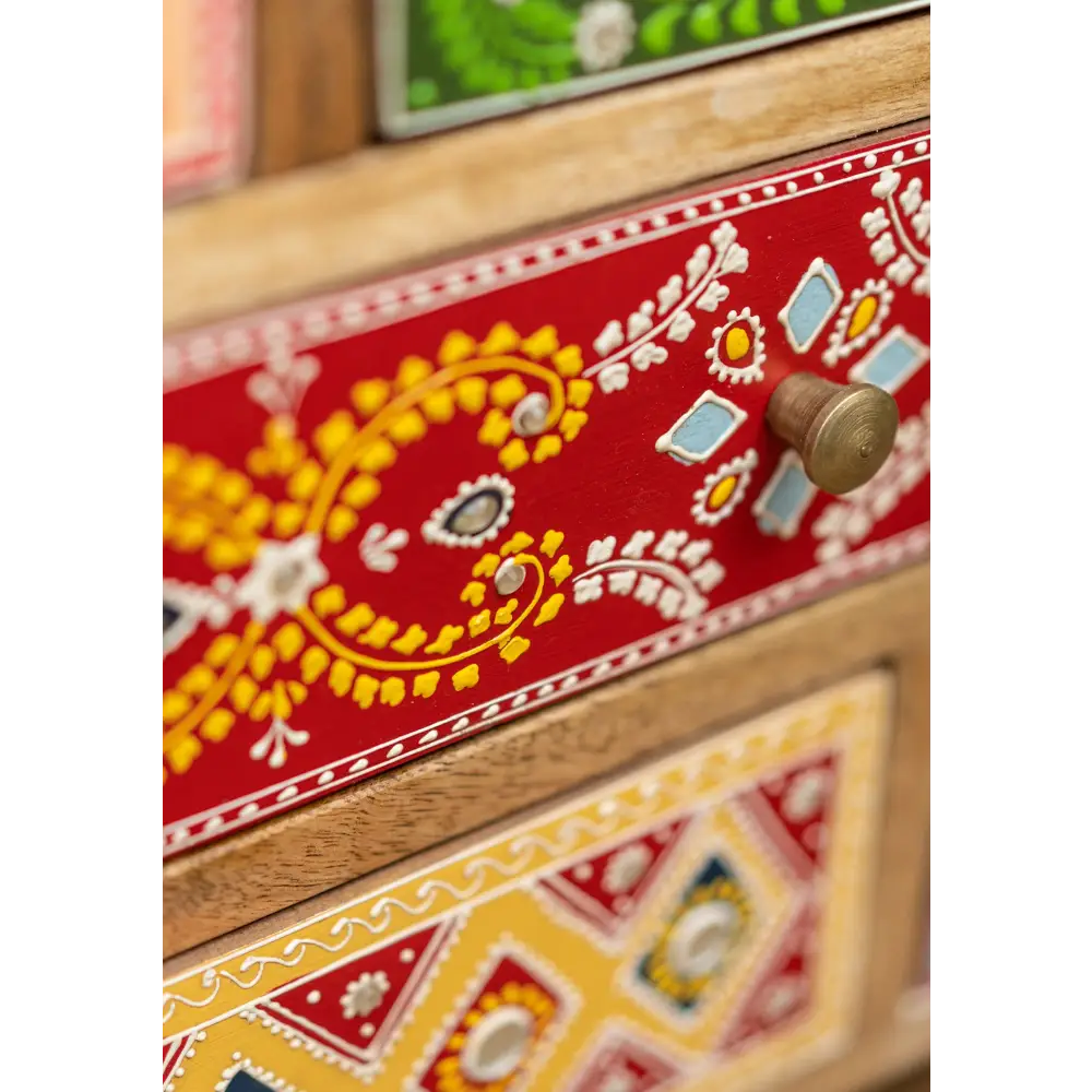 Hand-Painted 9-Drawer Sankalaka Cabinet. Decorative wooden dresser with colourful patterns.
