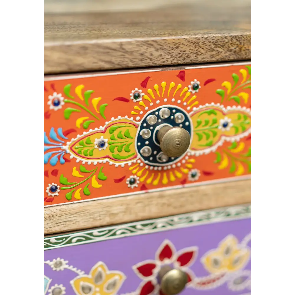 Hand-Painted 9-Drawer Sankalaka Cabinet. Decorative wooden dresser with colourful floral patterns and a metallic button