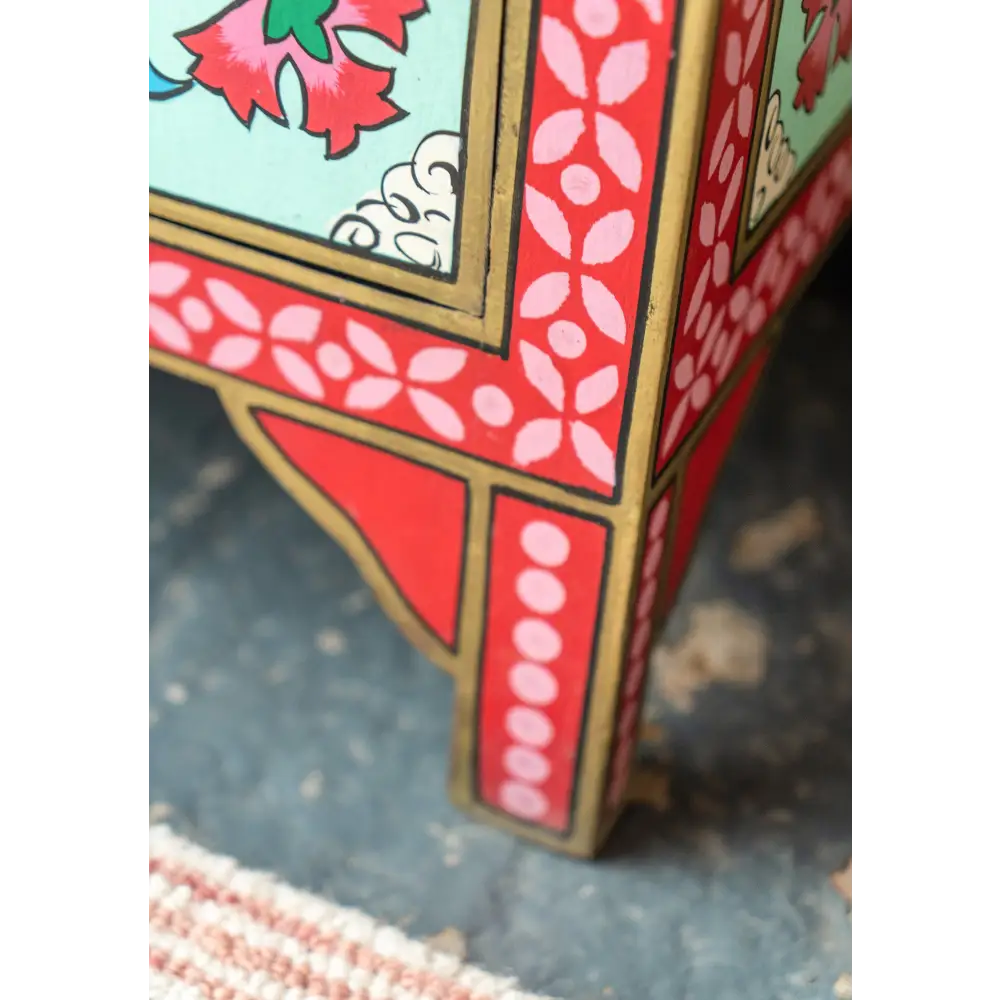Hand-Painted Double Door Cupboard Decorative corner detail of a traditional wooden box with floral patterns