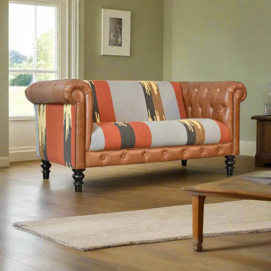 Multicoloured sofa with brown leather trim in a sitting room