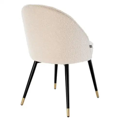 Luxury cream chair with black legs and gold toes 