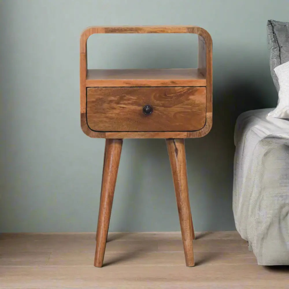 Eco-friendly home decor. Wooden bedside table with a drawer and shelf. Sustainable furniture.