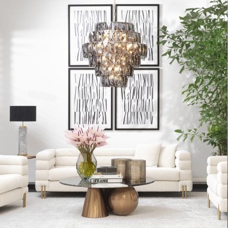 Modern living room with white sofa, chandelier, and decorative elements.