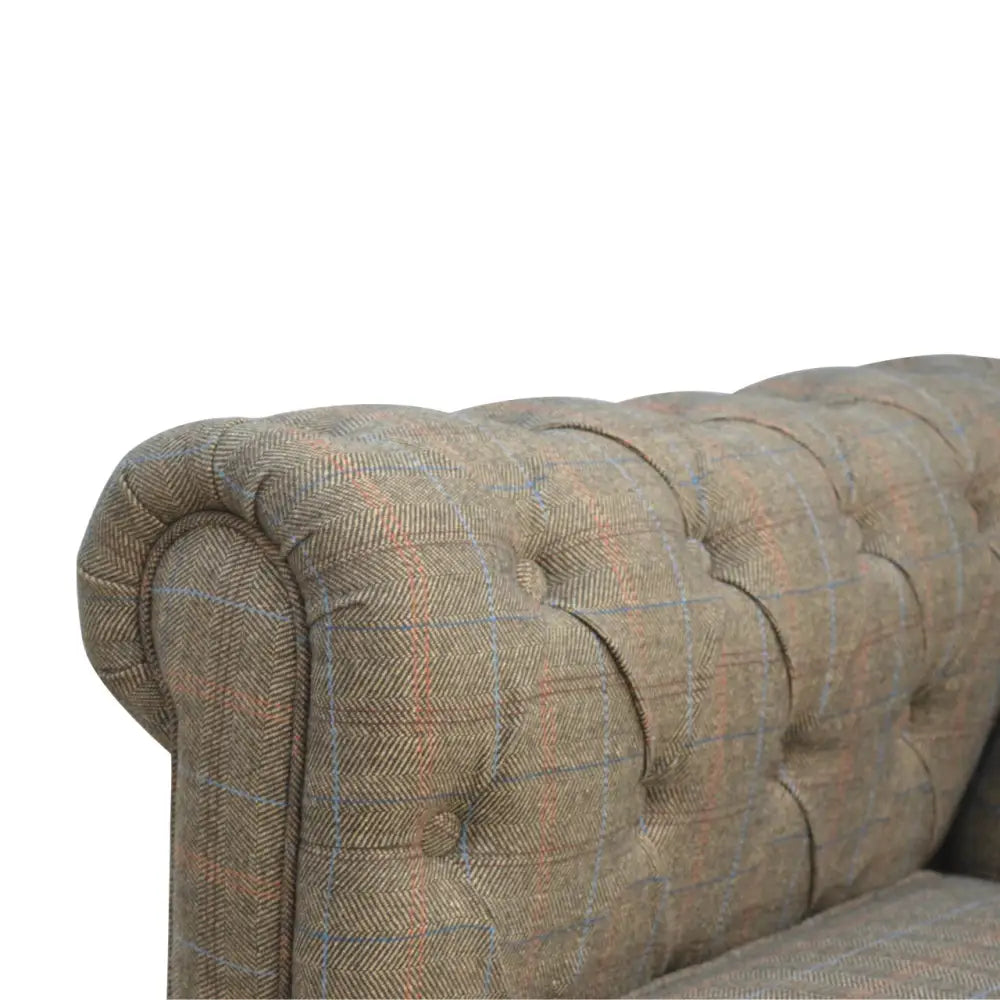 Tweed chesterfield sofa. Close-up of a textured sofa with a plaid pattern 