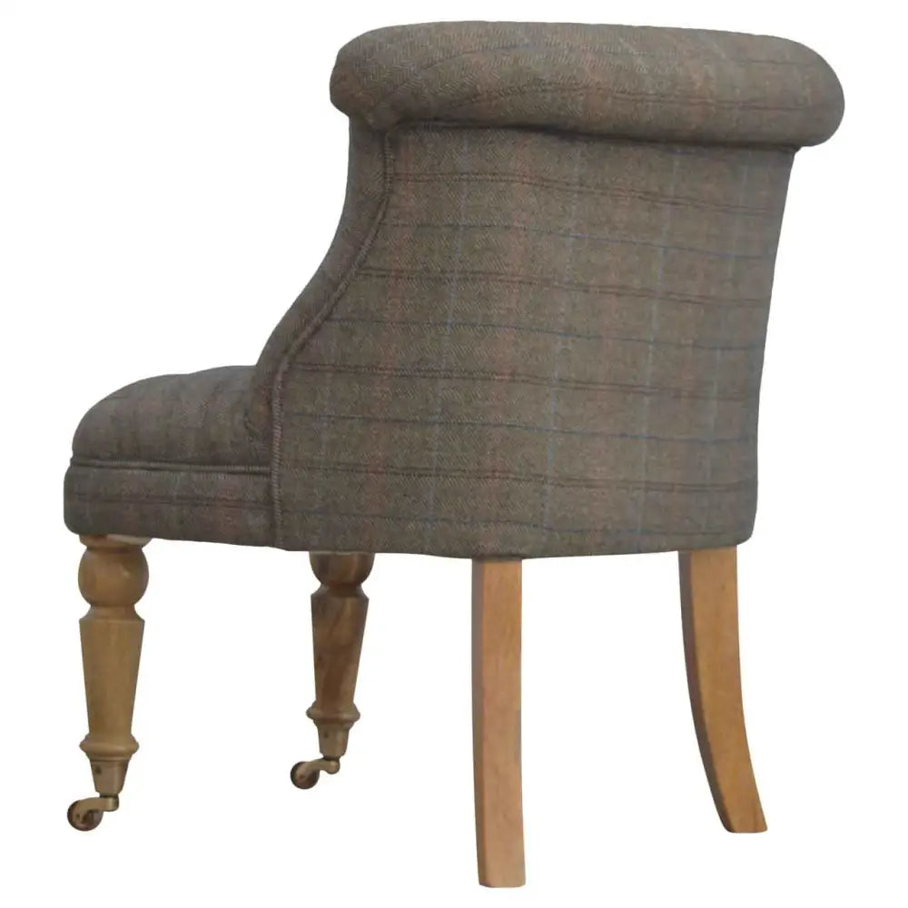Tweed occasional chair. Chair with plaid fabric and wooden legs 