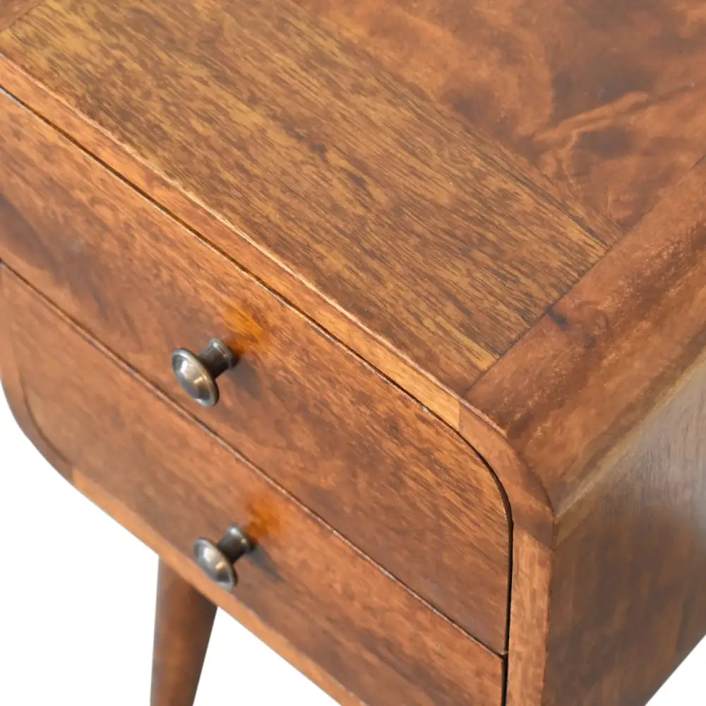 Sustainable furniture. Wooden Bedside Cabinet with 2 Drawers. Close-up of a wooden side table with two drawers and metal handles. Eco-friendly home decor.